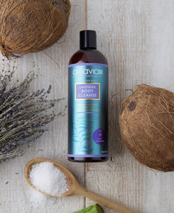 Aleavia lavender body wash on a table with some coconuts