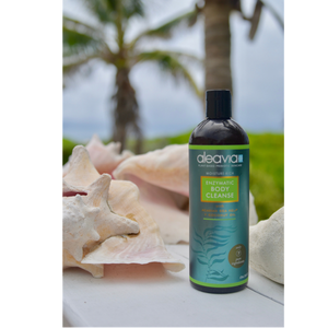 Bottle of Aleavia Enzymatic Body Wash near the ocean