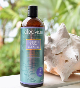 Aleavia Lavender Body Cleanse bottle on a table next to a seashell